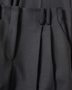 Veronica Beard Black pleated trousers in a woven fabric.