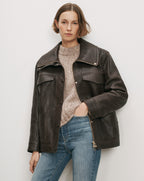 Veronica Beard Brown leather jacket, beige sweater, blue jeans