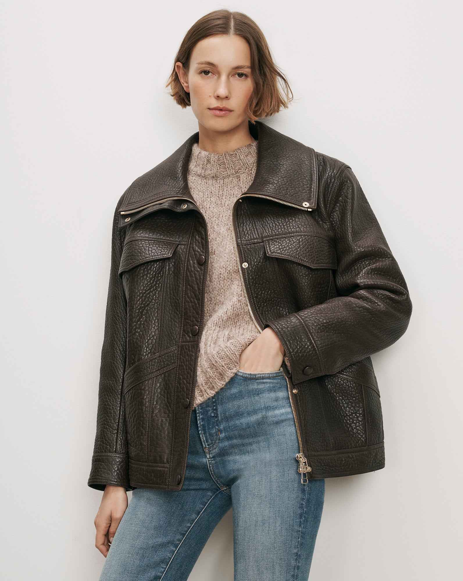 Veronica Beard Brown leather jacket, beige sweater, blue jeans