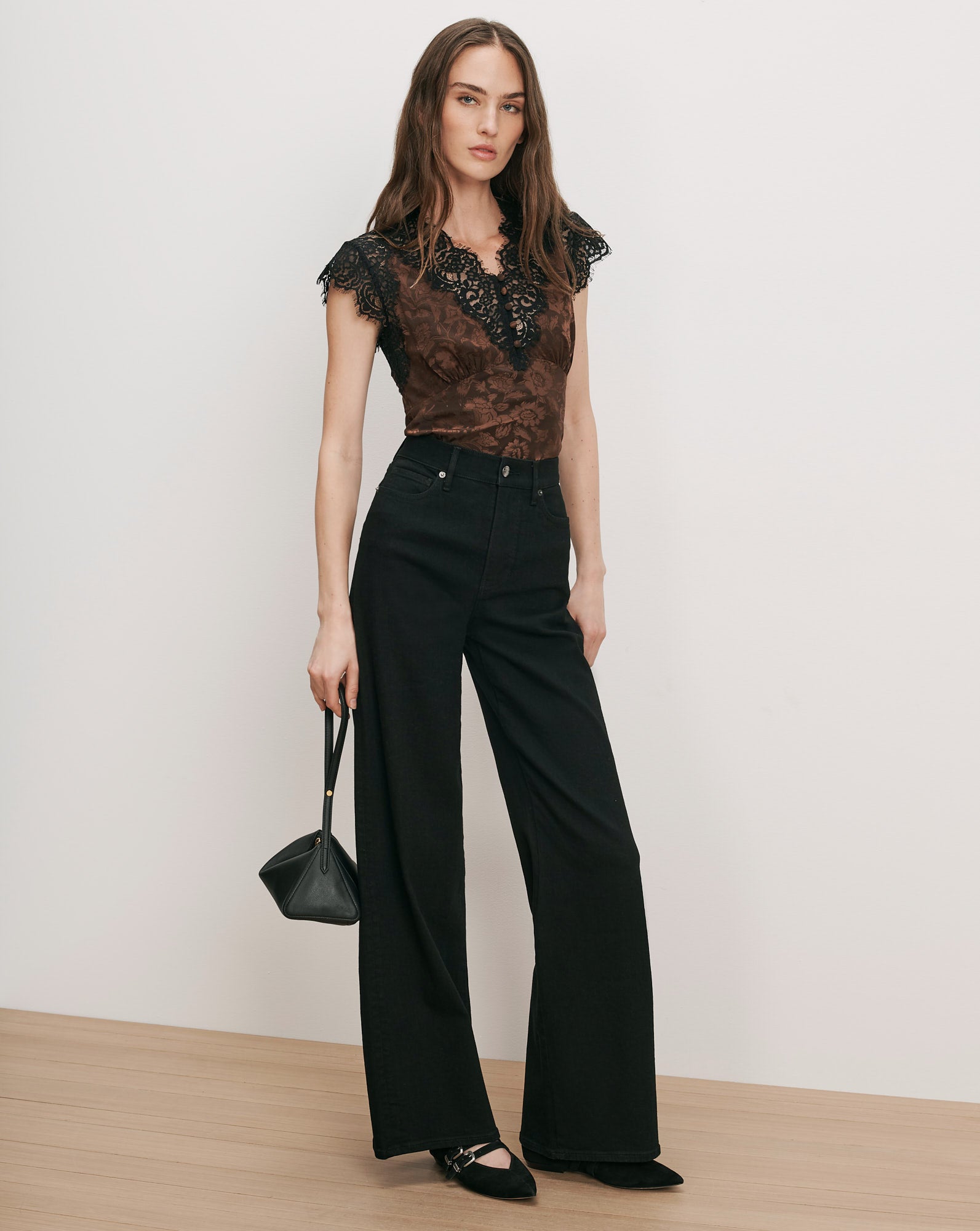 Veronica Beard Brown lace-trim top, black wide-leg jeans, black heels, black purse.