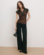 Veronica Beard Brown lace-trim top and black wide-leg pants.