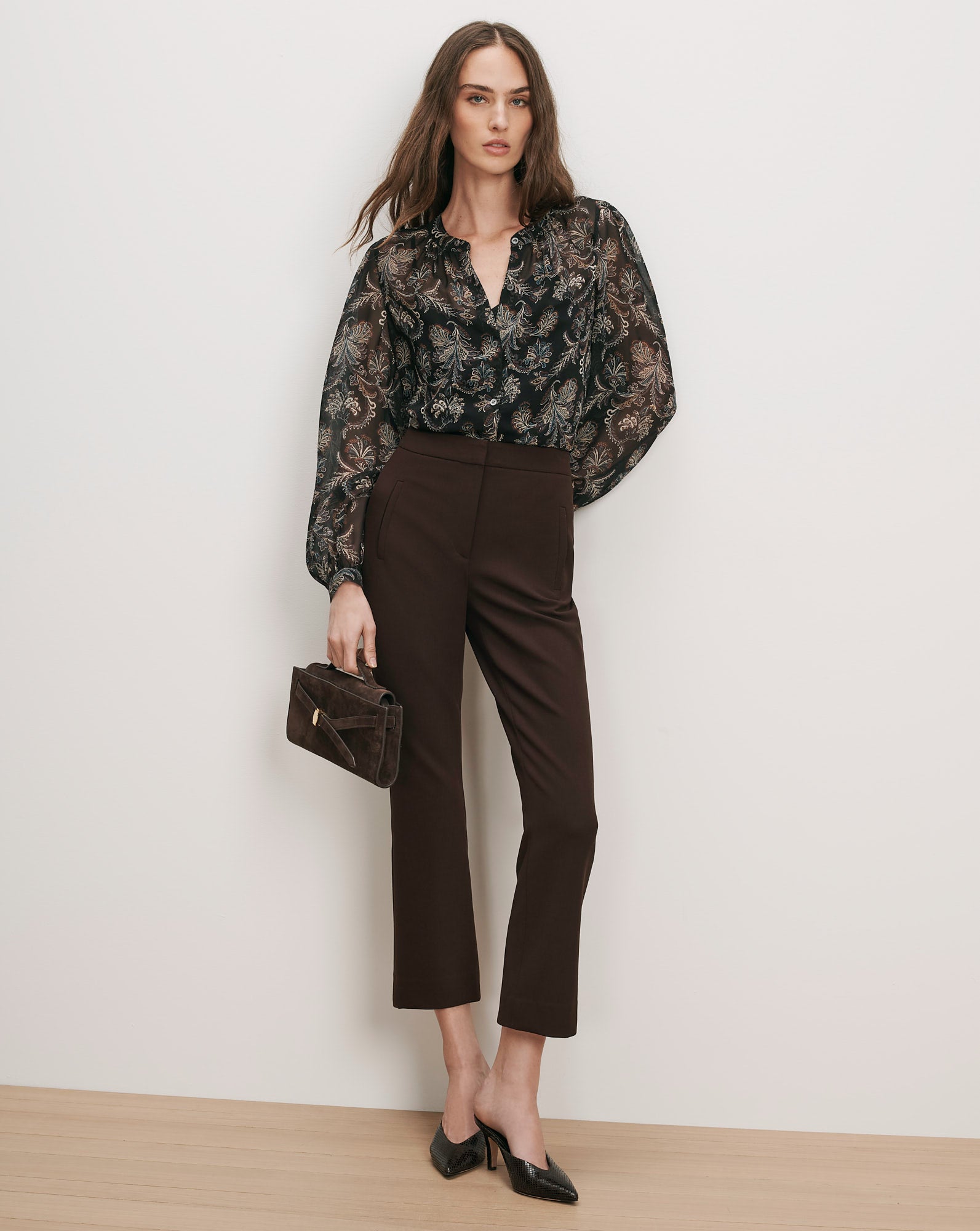 Veronica Beard Black floral sheer blouse and brown cropped trousers.