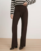 Veronica Beard Brown wide-leg trousers with a striped sweater.
