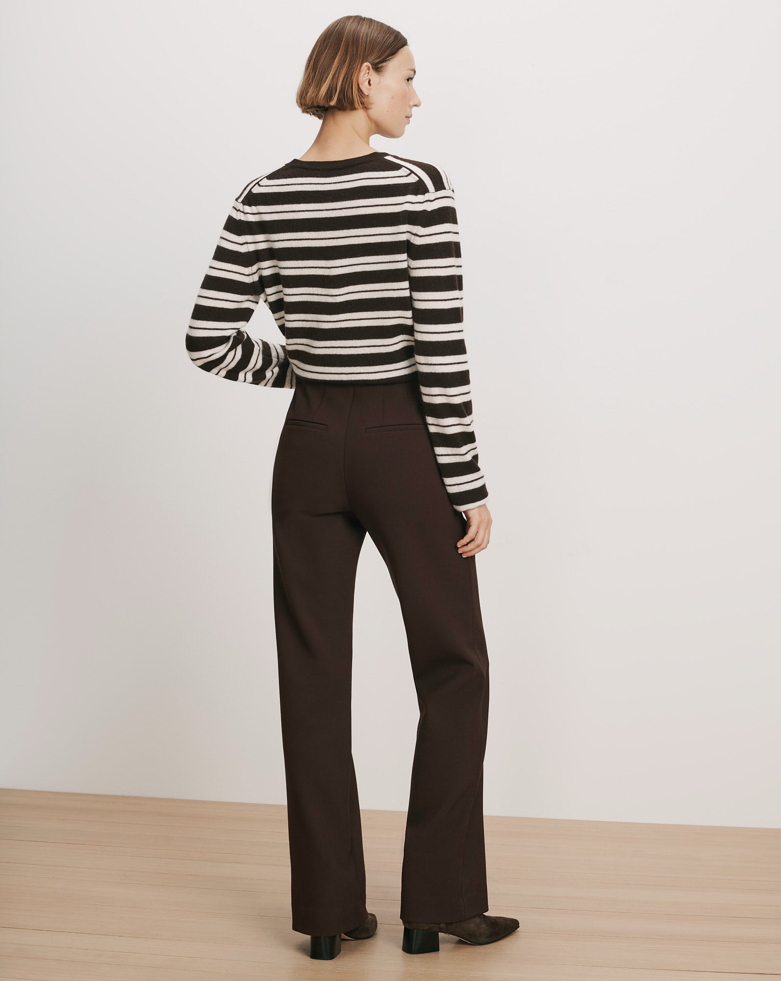 Veronica Beard Brown and white striped sweater, brown trousers.