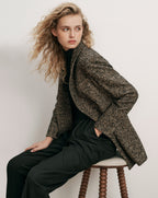 Veronica Beard Brown tweed blazer, black turtleneck, and black trousers.