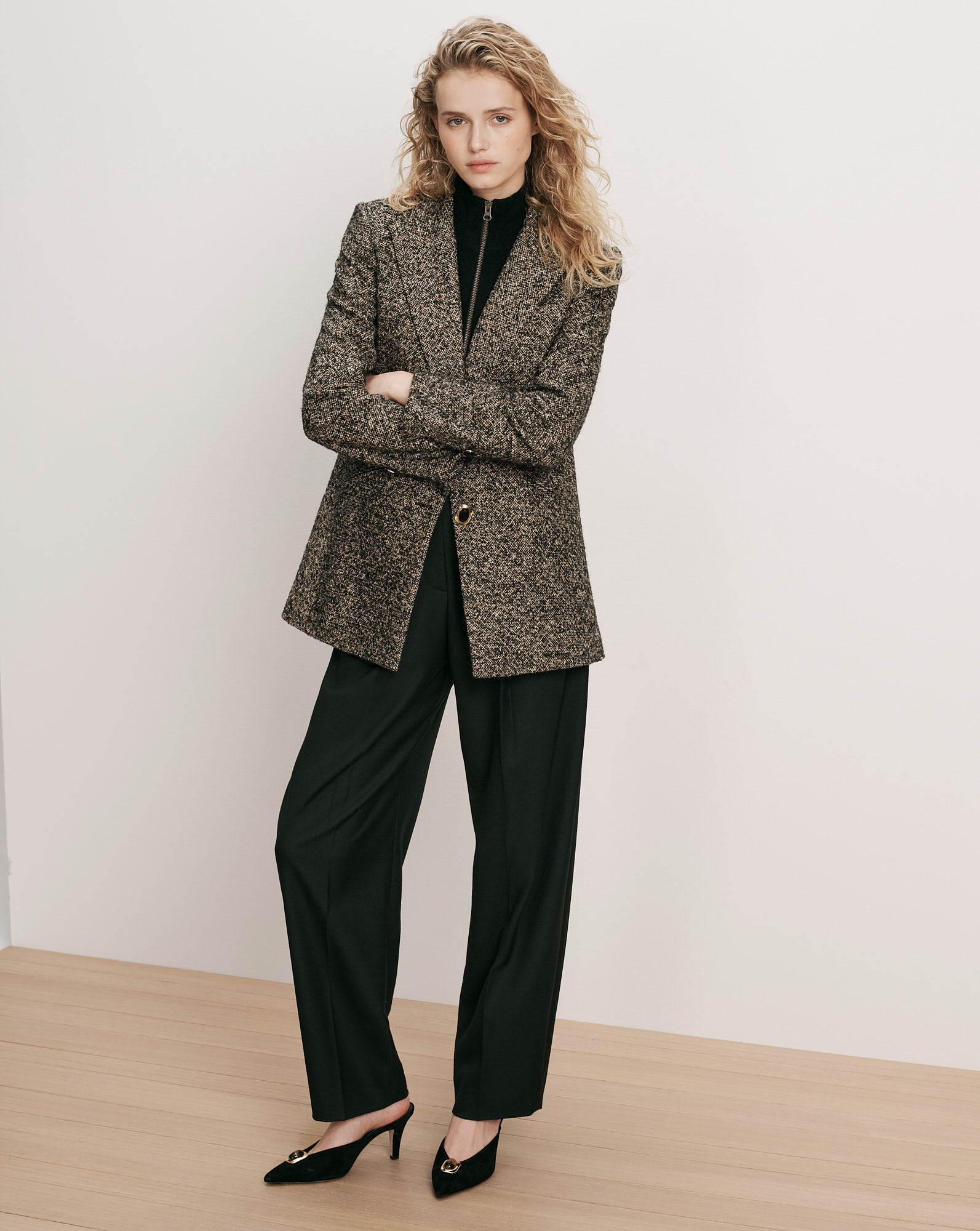 Veronica Beard Brown tweed blazer, black turtleneck, black trousers, black mules.