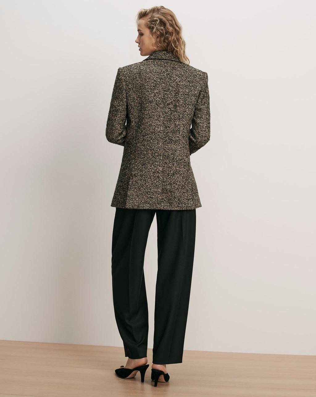 Veronica Beard Black and tan tweed blazer and black trousers.