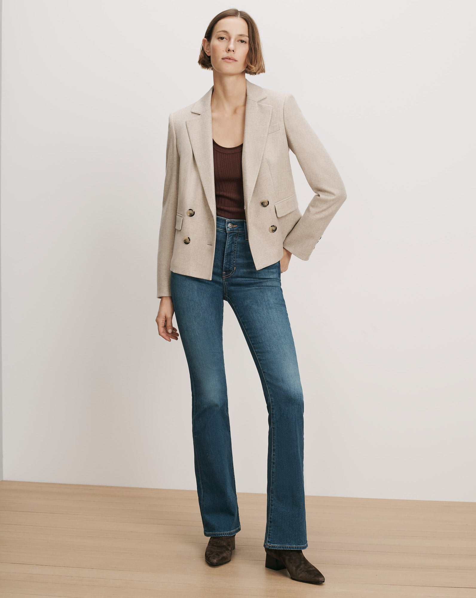 Veronica Beard Beige double-breasted blazer, brown tank top, blue flare jeans.