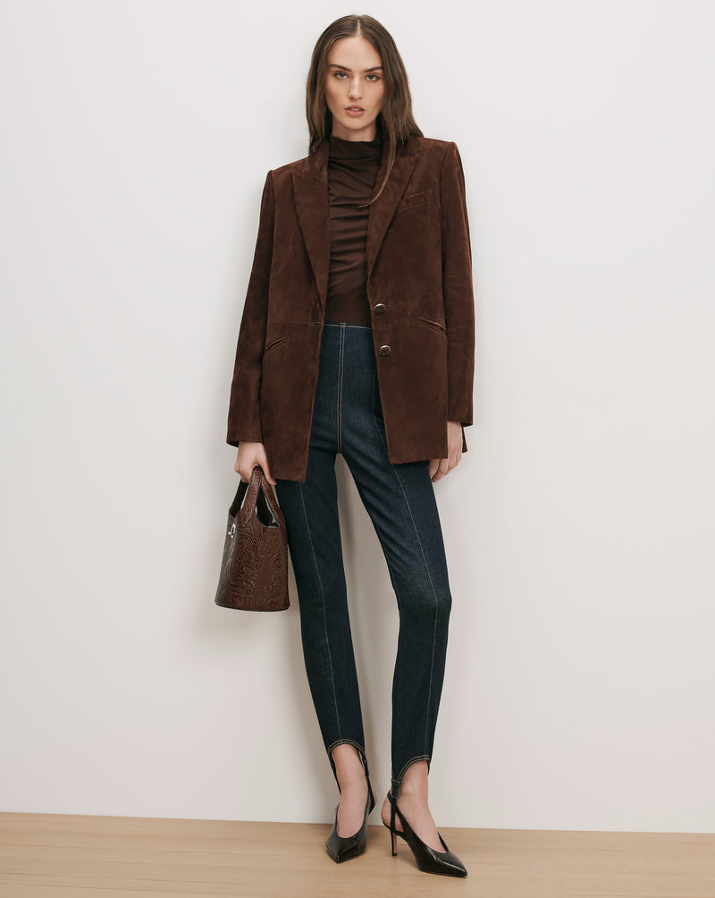 Veronica Beard Brown suede blazer, brown turtleneck, dark wash stirrup leggings.