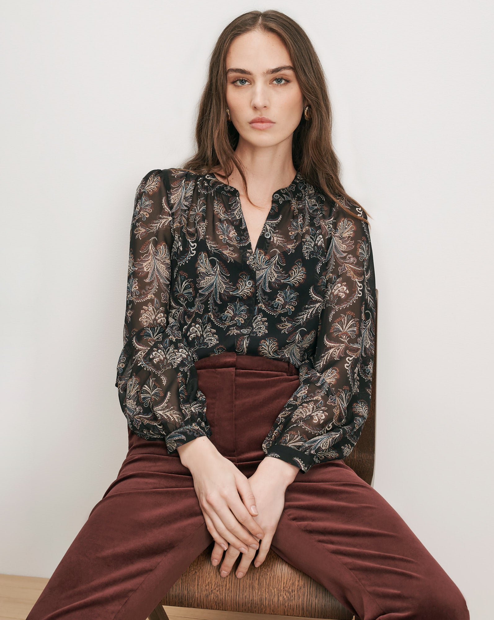 Veronica Beard Black sheer paisley blouse and brown velvet pants.
