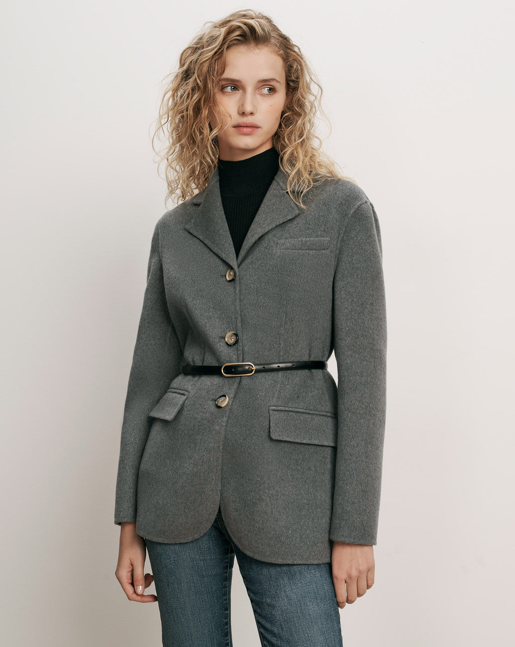 Veronica Beard Gray wool blazer, belted, over black turtleneck.