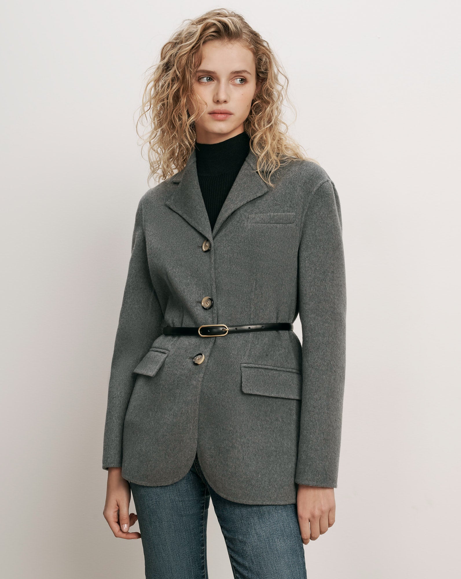 Veronica Beard Gray wool blazer, belted, over black turtleneck.