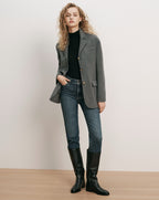Veronica Beard Gray blazer, black turtleneck, blue jeans, black boots.