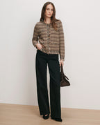 Veronica Beard Brown tweed cardigan, black wide-leg jeans, brown handbag.