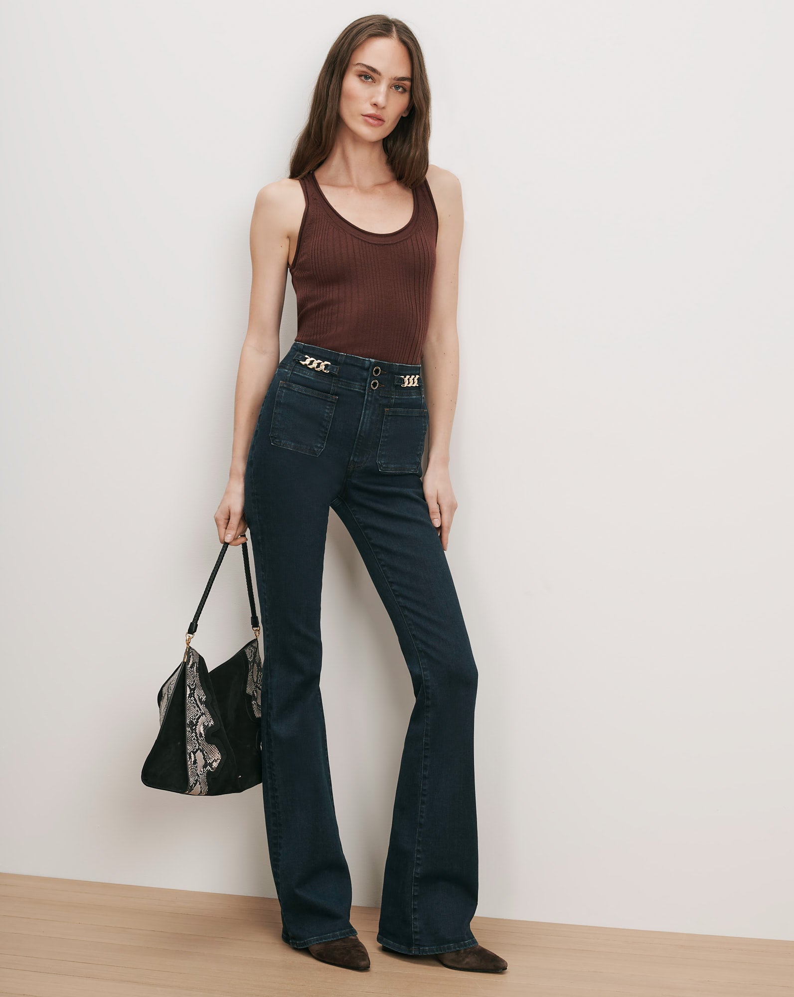 Veronica Beard Brown ribbed tank top, dark wash flare jeans with chain detail.