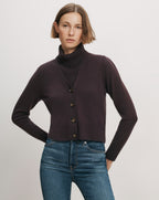 Veronica Beard Brown cropped cardigan over turtleneck.