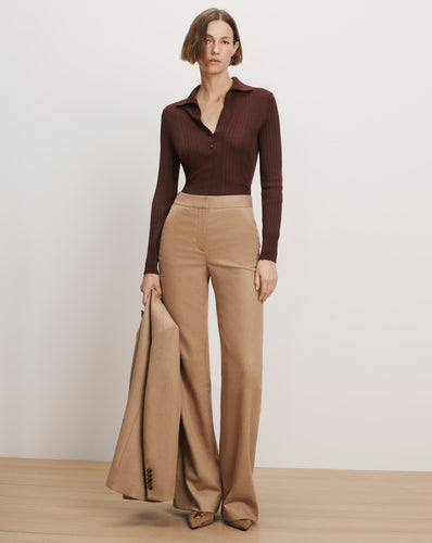 Veronica Beard Brown ribbed polo shirt, tan wide-leg trousers.