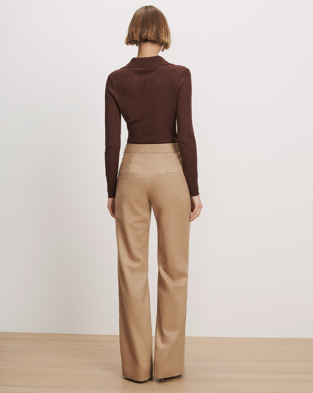 Veronica Beard Brown ribbed knit polo shirt, beige wide-leg trousers.
