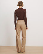 Veronica Beard Brown ribbed knit polo shirt, beige wide-leg trousers.