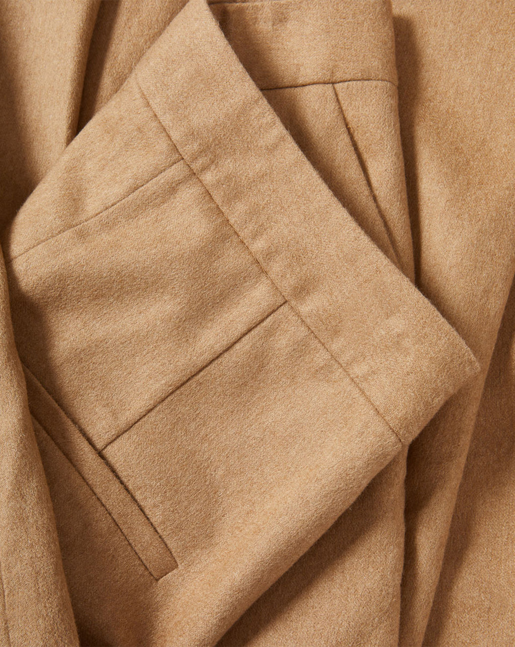 Veronica Beard Tan textured fabric folded with pleats.