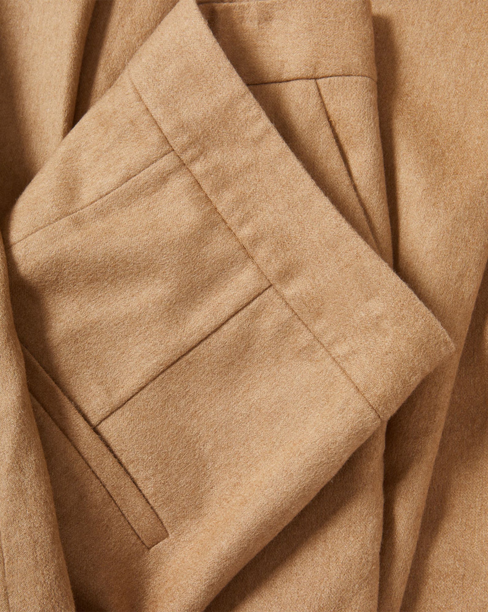Veronica Beard Tan textured fabric folded with pleats.