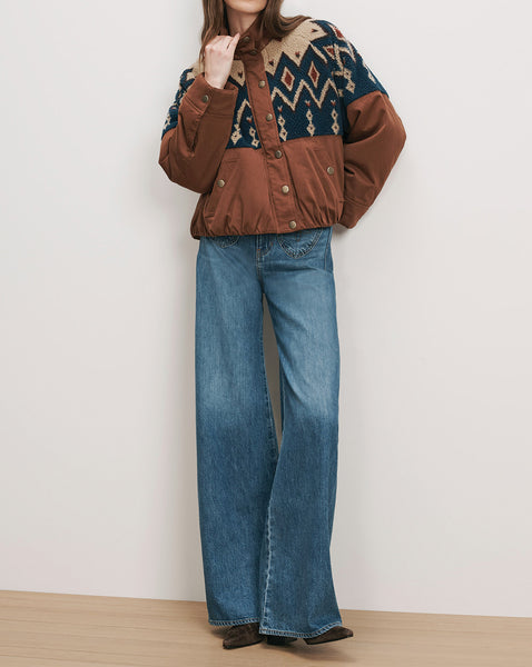 Veronica Beard Brown brown patterned jacket and blue wide-leg jeans.