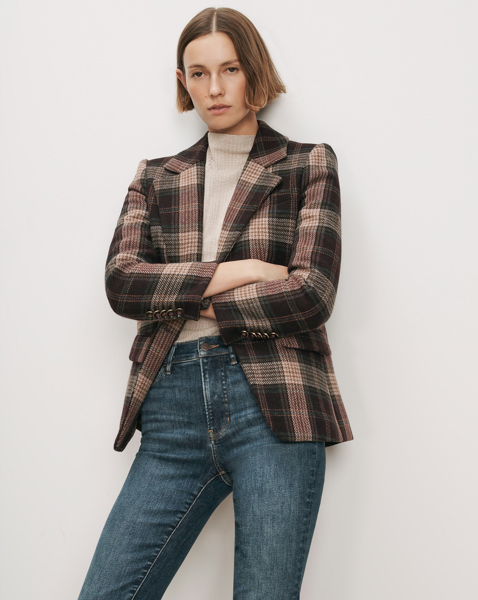 Veronica Beard Brown plaid blazer, cream turtleneck, blue jeans.