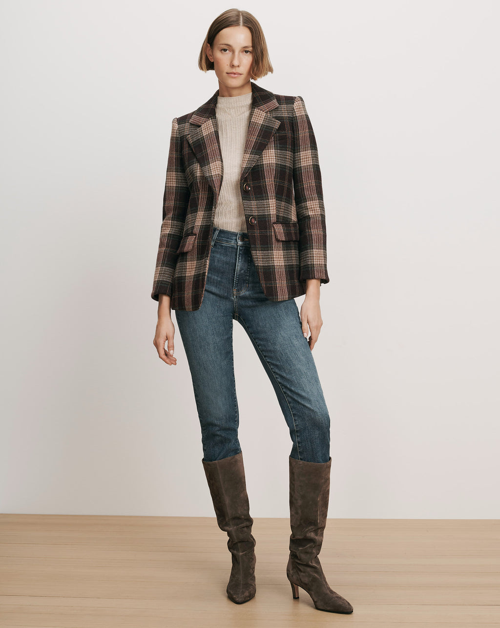 Veronica Beard Brown plaid blazer, cream sweater, blue jeans, brown boots.