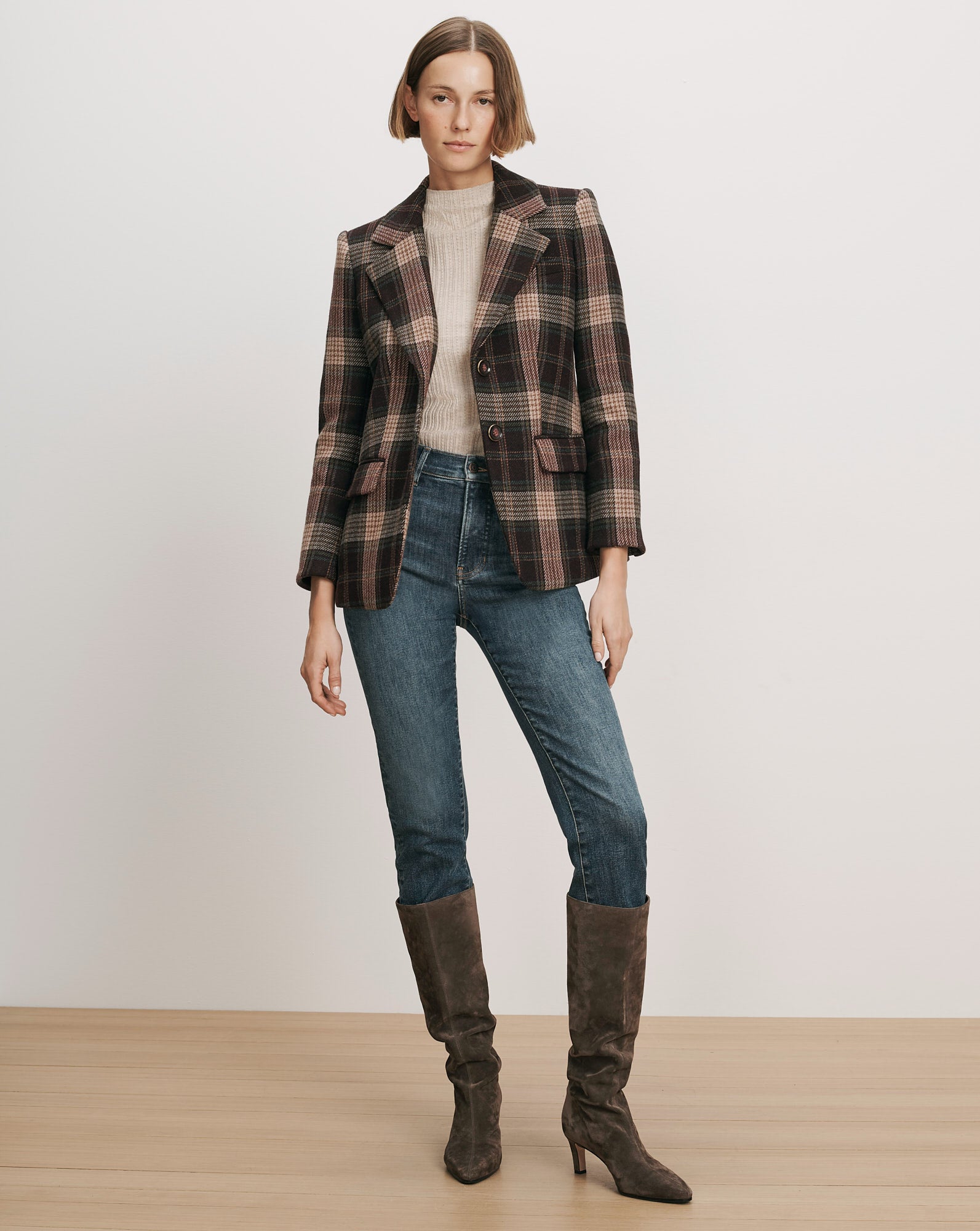 Veronica Beard Brown plaid blazer, cream sweater, blue jeans, brown boots.