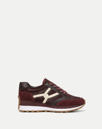 Veronica Beard Burgundy textured leather low-top sneaker with white logo.