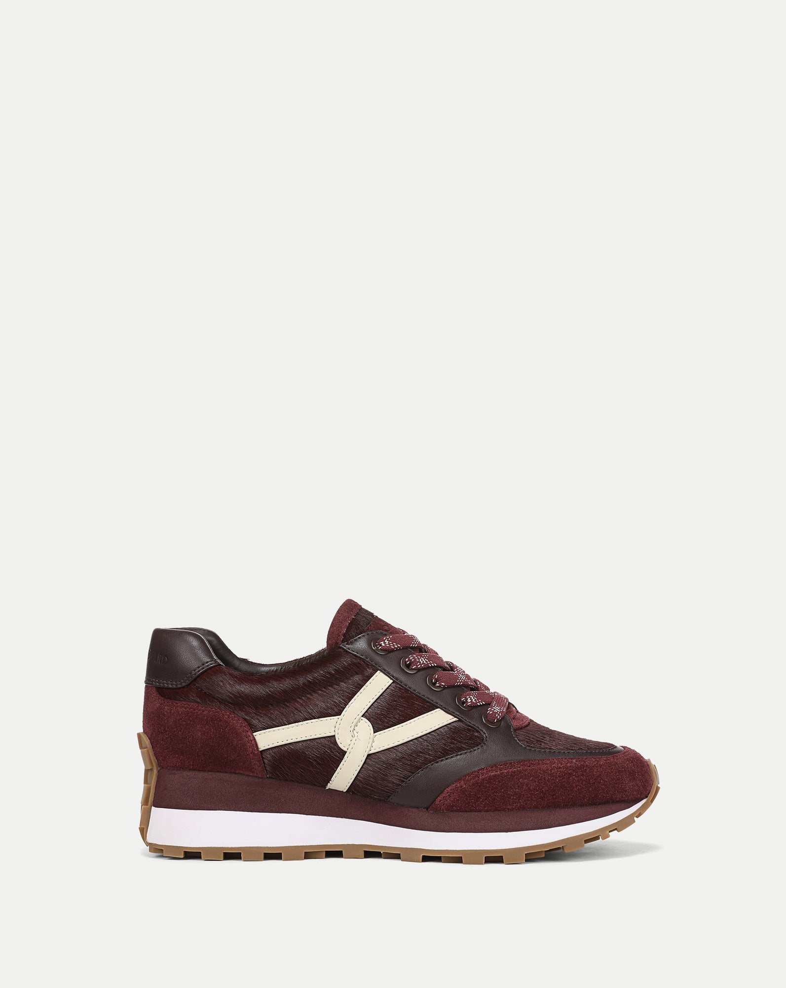 Veronica Beard Burgundy textured leather low-top sneaker with white logo.