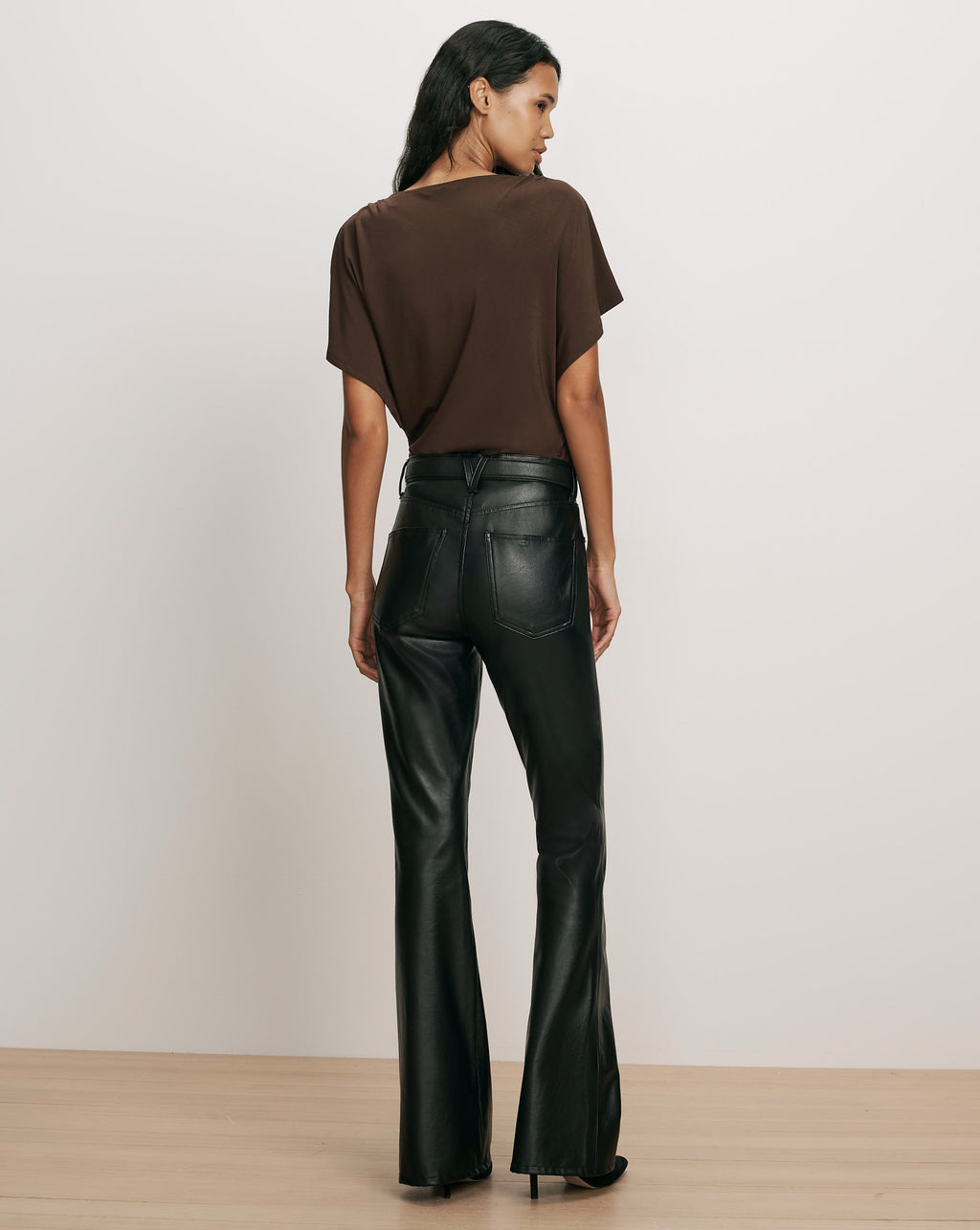 Veronica Beard Gray knit turtleneck sweater and black leather pants.