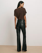 Veronica Beard Gray knit turtleneck sweater and black leather pants.