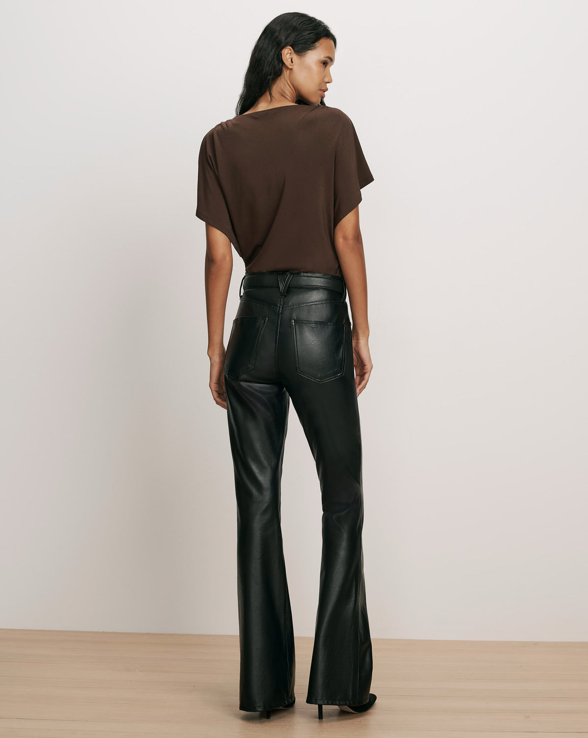 Veronica Beard Gray knit turtleneck sweater and black leather pants.