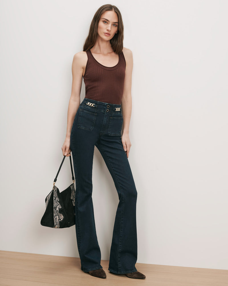 Veronica Beard Brown ribbed tank top, dark wash flare jeans with chain detail.