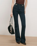 Veronica Beard Dark wash flared jeans with gold chain details.