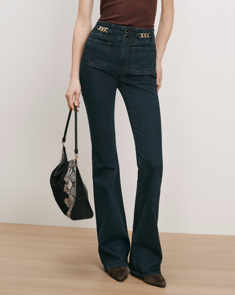 Veronica Beard Dark wash flared jeans with gold chain details.