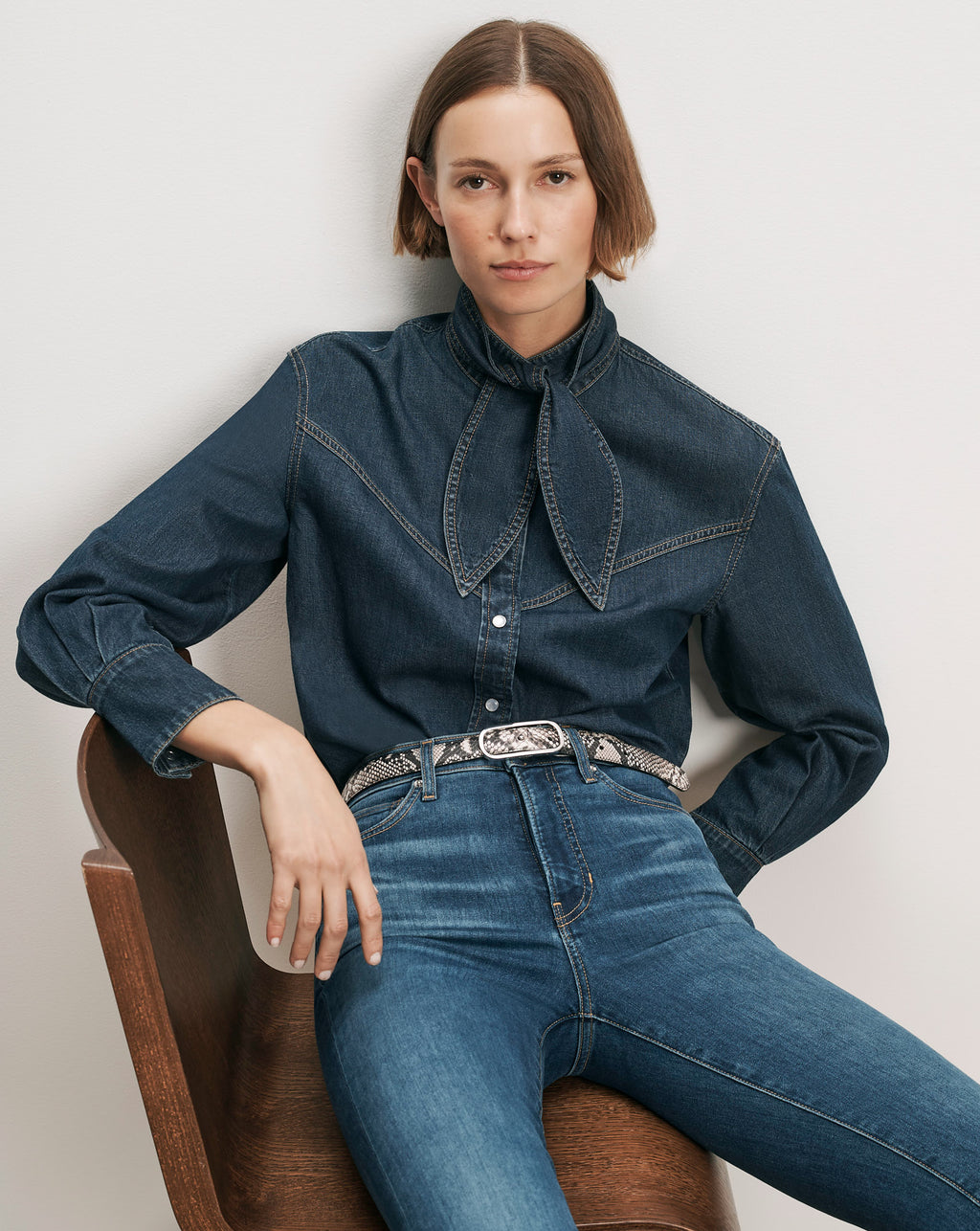 Veronica Beard Denim shirt with a bow collar and jeans.