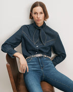 Veronica Beard Denim shirt with a bow collar and jeans.
