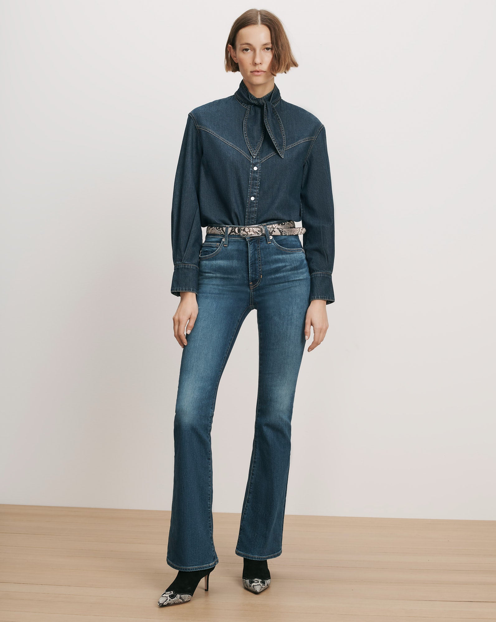 Veronica Beard Denim shirt and flared jeans with a snakeskin belt.