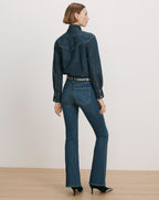 Veronica Beard Denim shirt and flared jeans with a patterned belt.