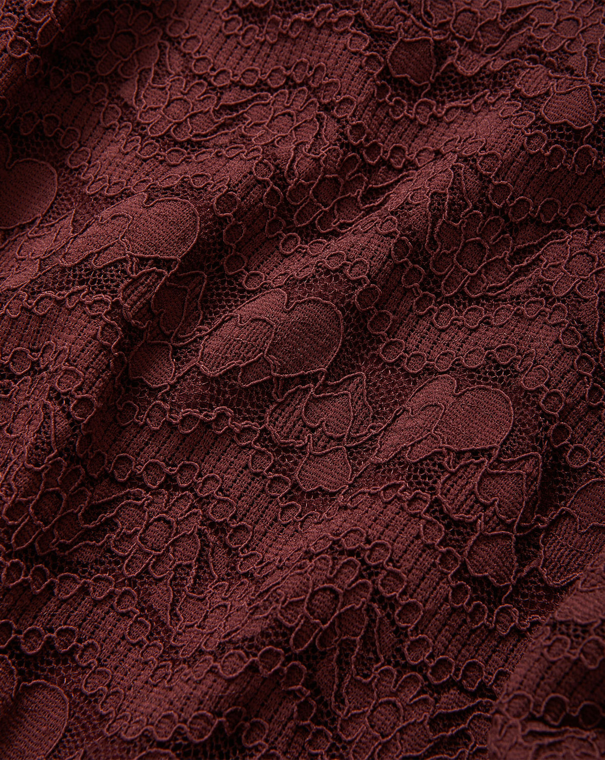 Veronica Beard Burgundy lace fabric with intricate floral patterns.