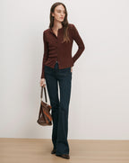 Veronica Beard Brown ribbed cardigan, dark wash flare jeans.