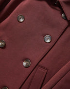 Veronica Beard Burgundy double-breasted coat with brown buttons.