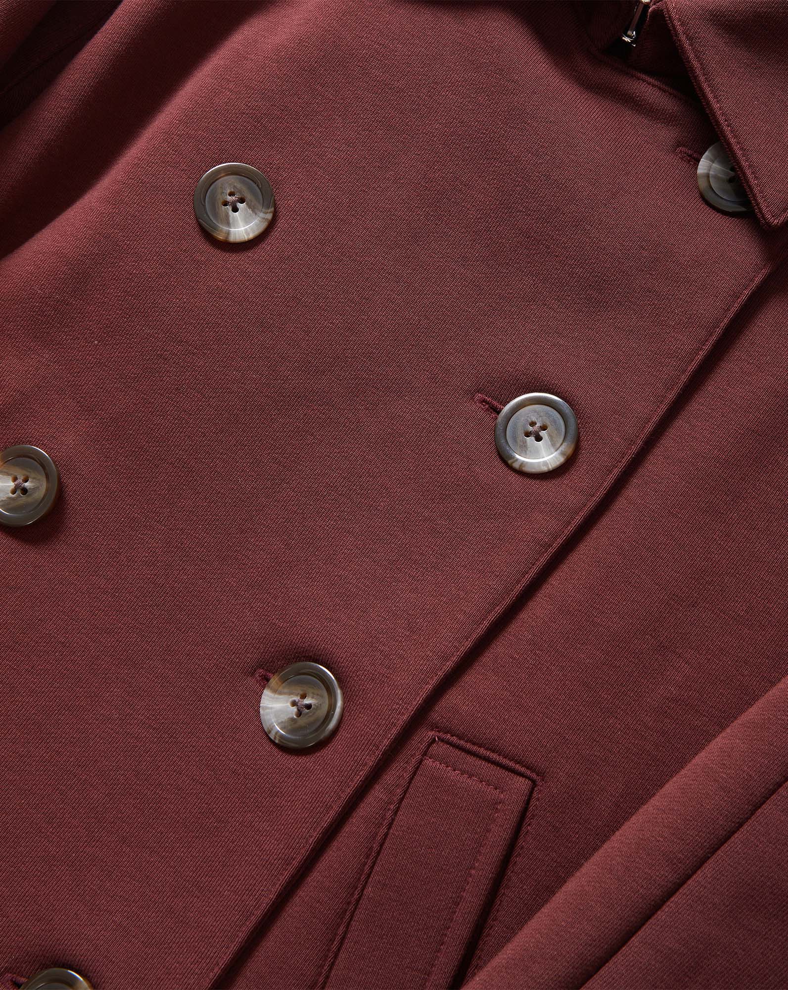 Veronica Beard Burgundy double-breasted coat with brown buttons.