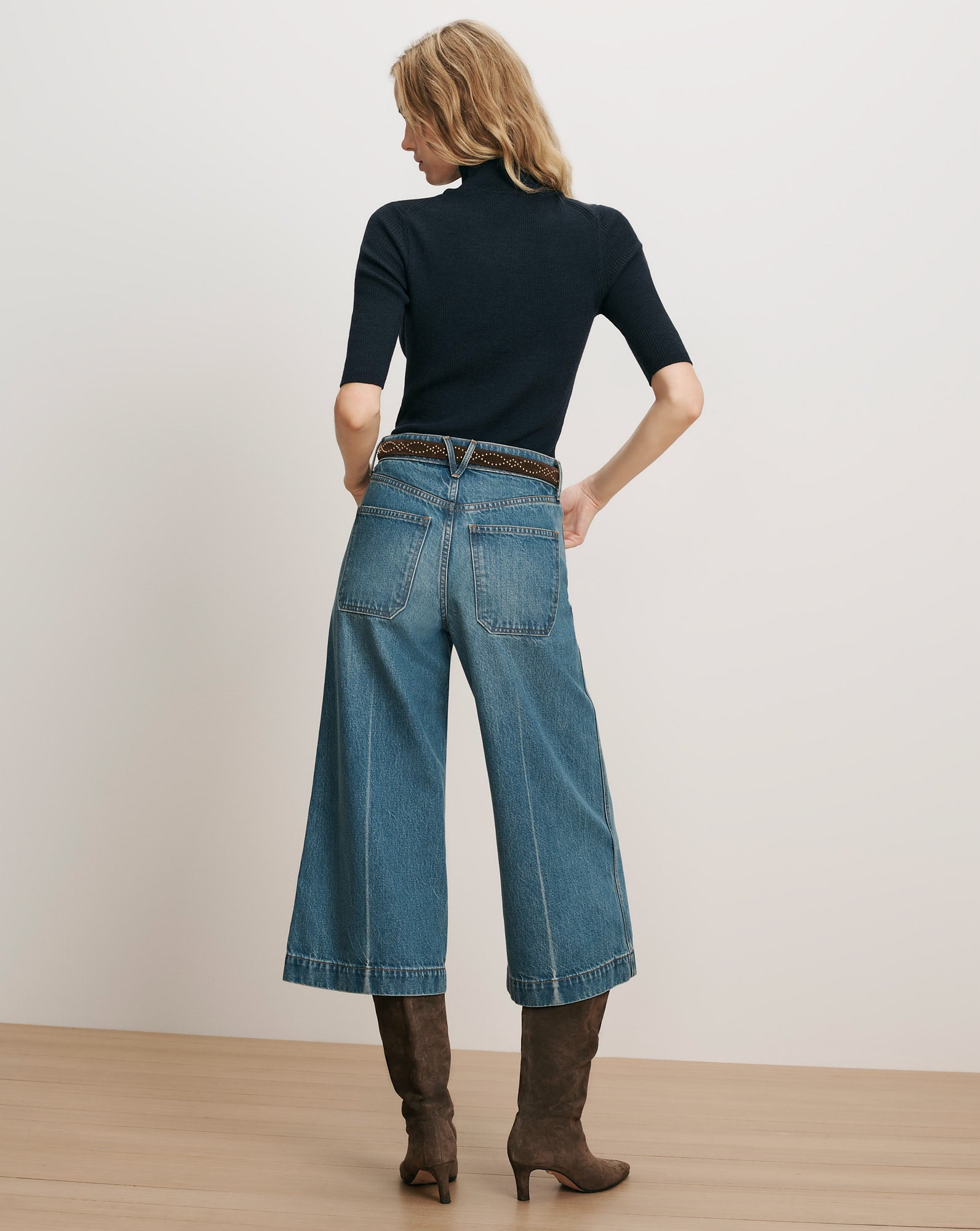 Veronica Beard Navy ribbed turtleneck, wide-leg cropped jeans, brown boots.