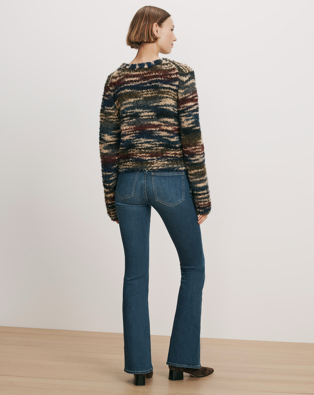 Veronica Beard Striped multicolor fuzzy sweater and blue flare jeans.