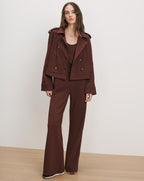 Veronica Beard Brown peacoat, tank top, and wide-leg pants set.