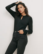 Veronica Beard Black long-sleeve top with keyhole neckline and button cuffs.