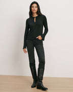 Veronica Beard Black long-sleeve keyhole top, black jeans, black boots.